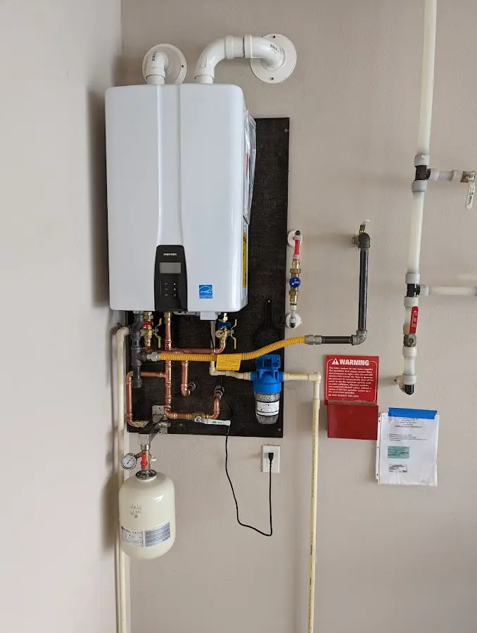 Professional plumber installing copper piping in a Hamtramck home